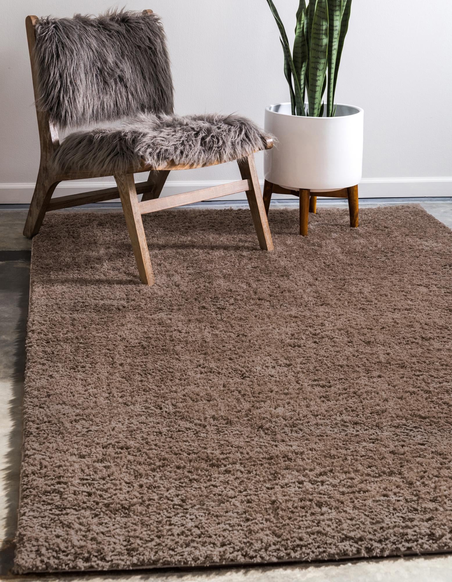A soft, plush 8x10 rectangular shag rug in a solid brown color, perfect for a cozy living room or bedroom.