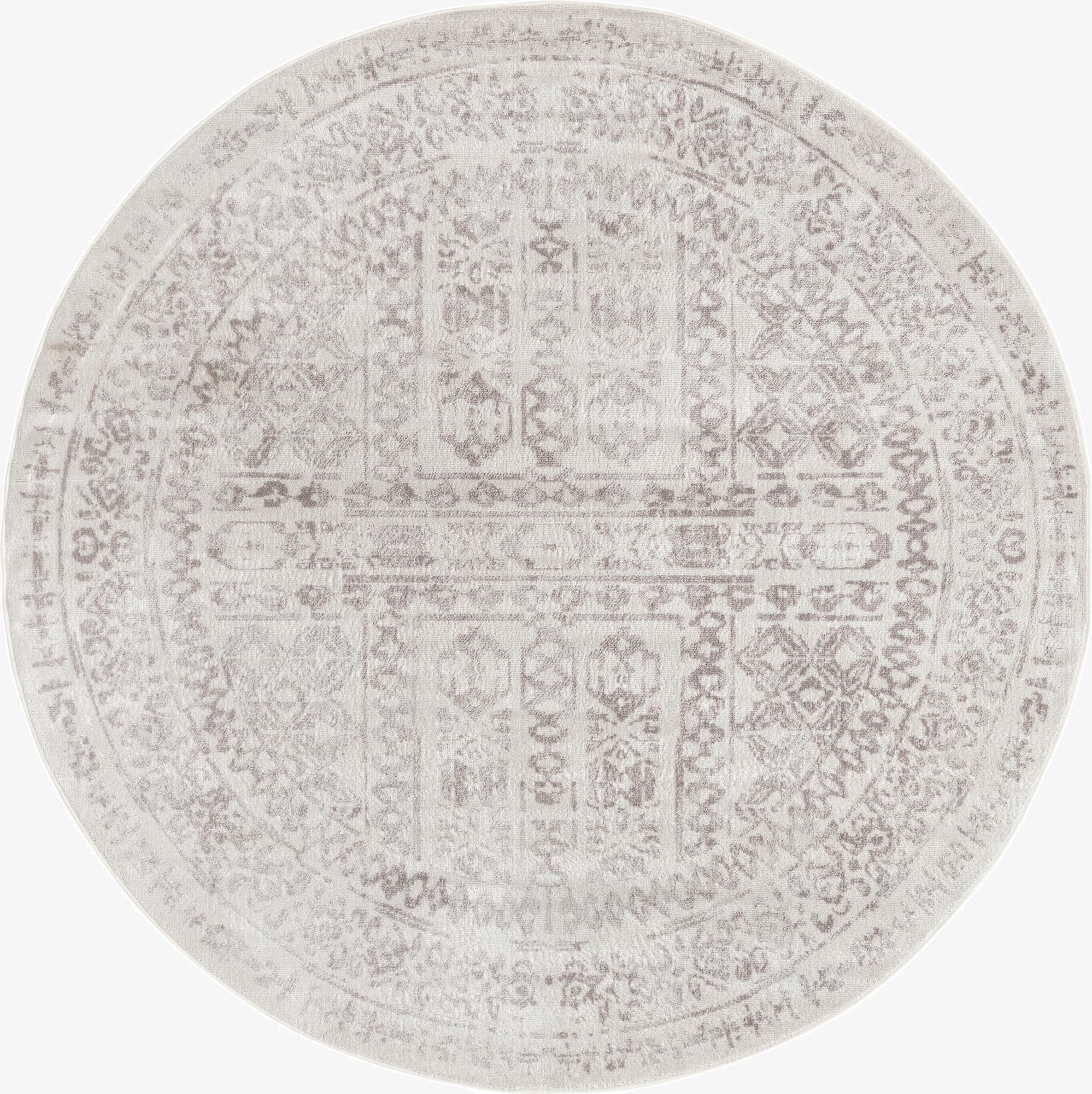 A 7' round ivory and cream rug with a distressed Bohemian medallion pattern, suitable for a living room.