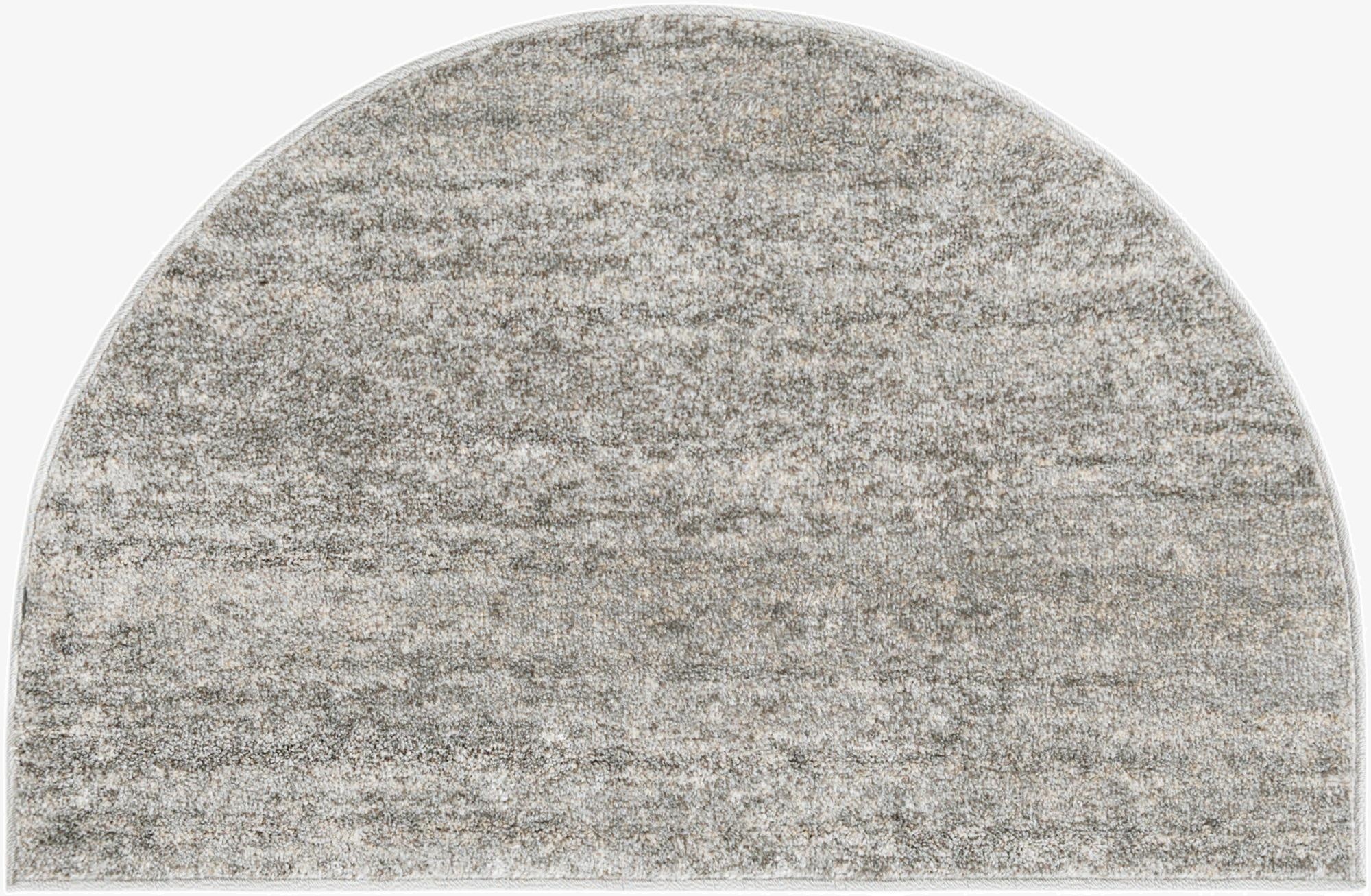 A 2' 7 x 4' 0 hearth-shaped gray polypropylene rug with a subtle, textured solid pattern, ideal for indoor use.