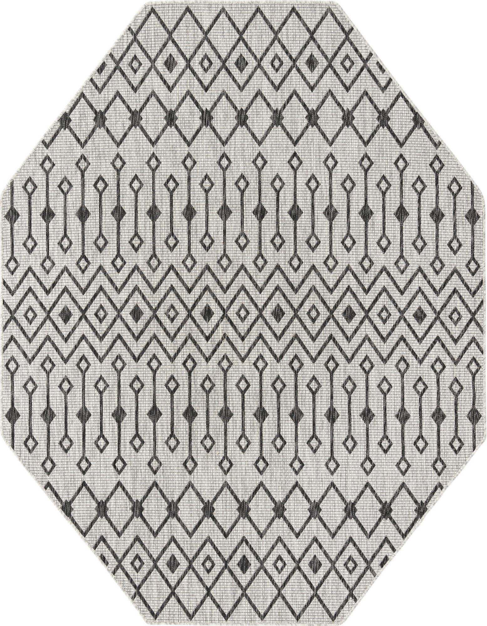 An octagon-shaped gray and silver flatweave rug with a repeating tribal geometric pattern of diamonds and vertical lines.