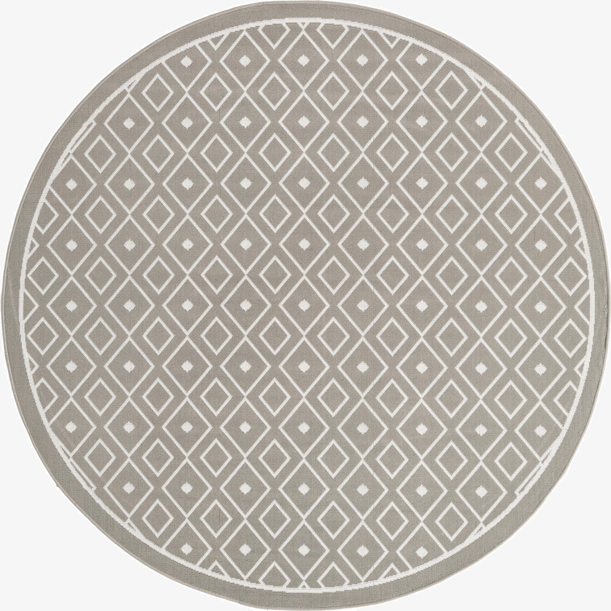 A 7' round gray indoor/outdoor rug with a modern Scandinavian lattice pattern of white diamonds, ideal for a patio.
