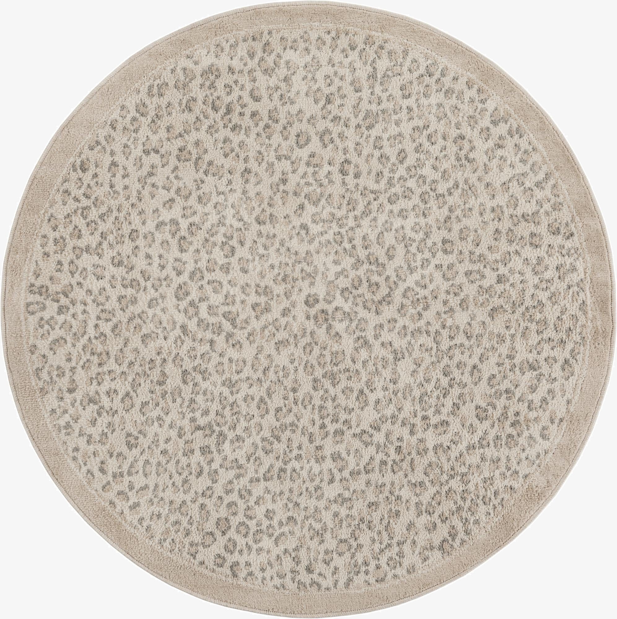 A 5' 0 x 5' 0 round ivory and cream rug with a subtle modern leopard print pattern and a solid border.
