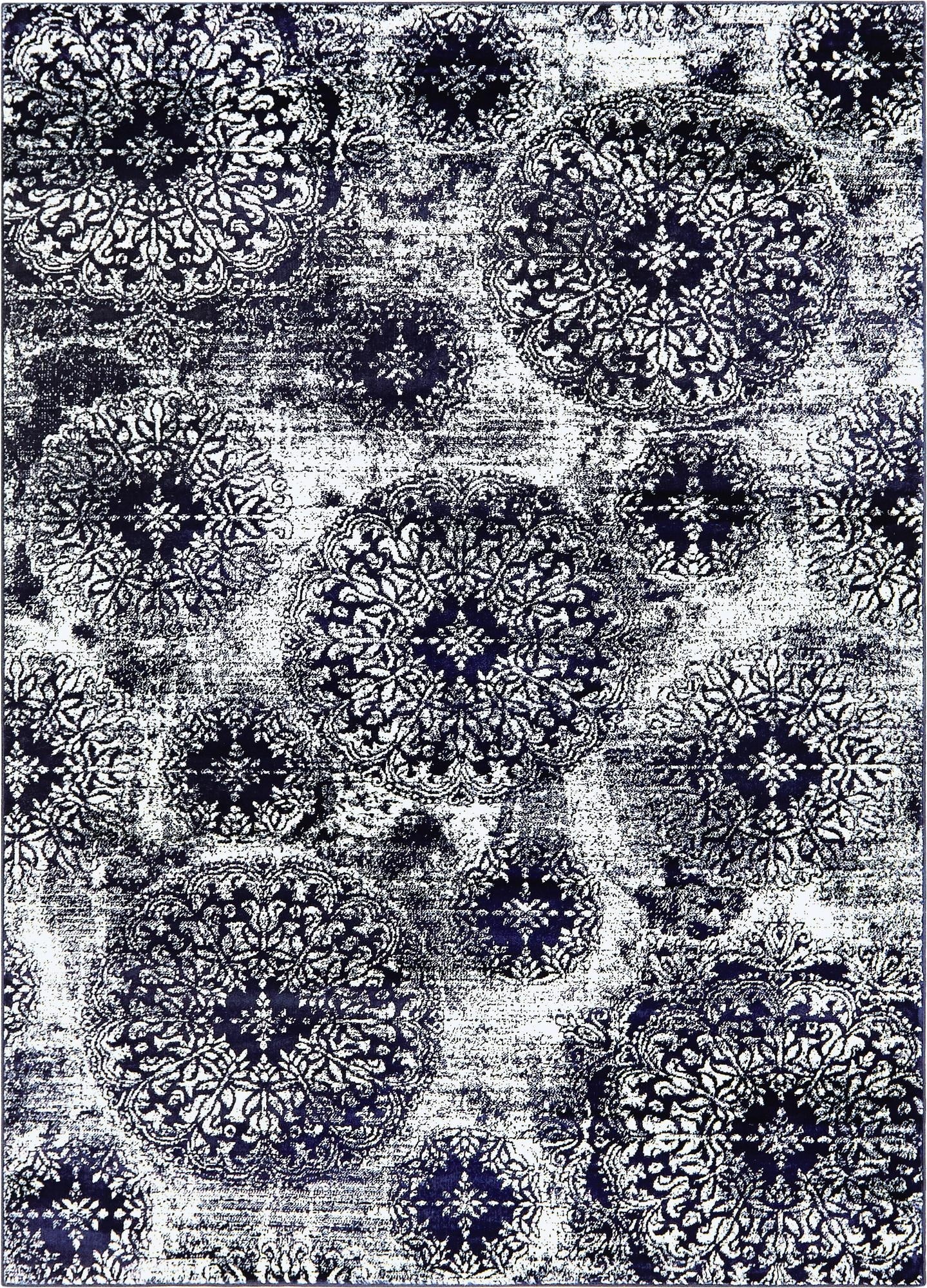 A 7x10 rectangular Monte Carlo rug featuring a distressed navy blue and white floral medallion pattern, suitable for a living room.