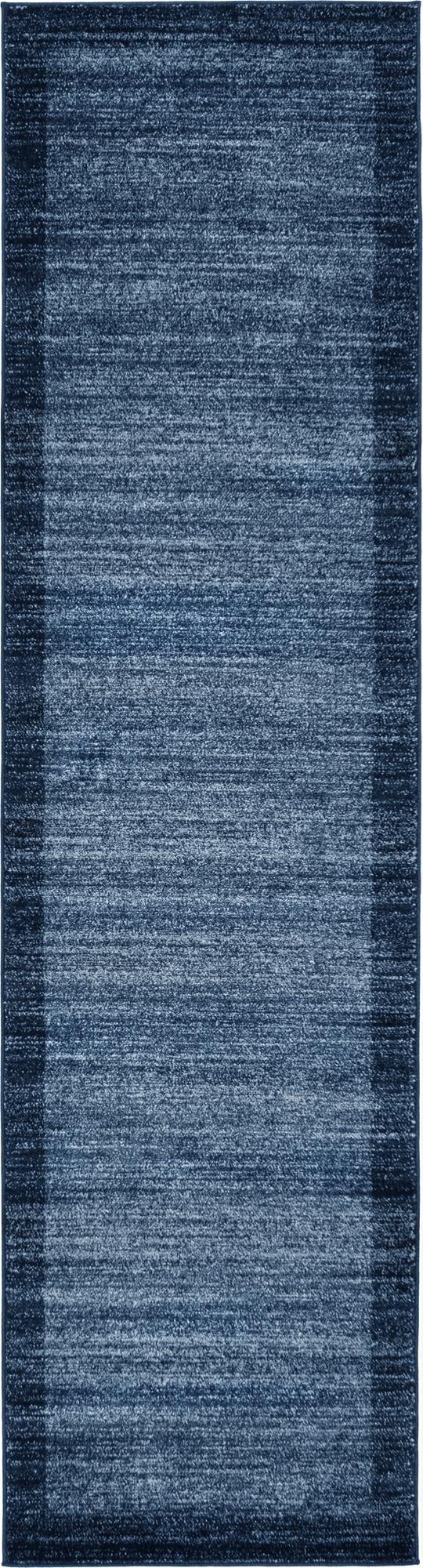 A 10 ft runner rug from the Angelica collection in varying shades of blue, featuring a subtle textured pattern and a darker blue border.