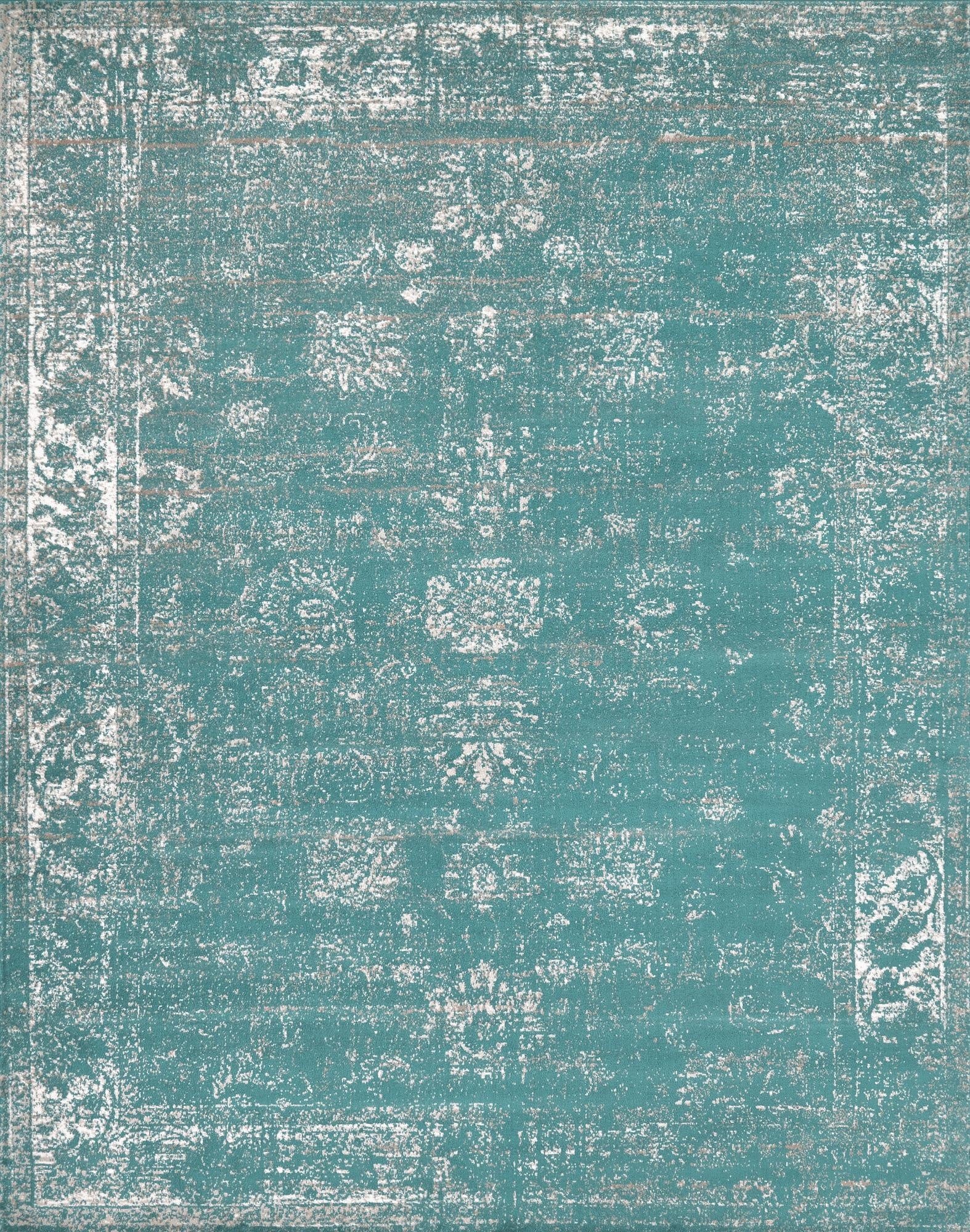A rectangular 8x10 Monte Carlo rug in shades of blue with a distressed bohemian medallion pattern and white accents.